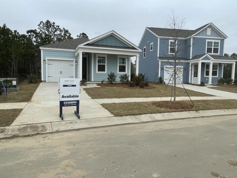 Two charming blue homes with covered porches in Sheep Island by D.R. Horton (Summerville, SC).