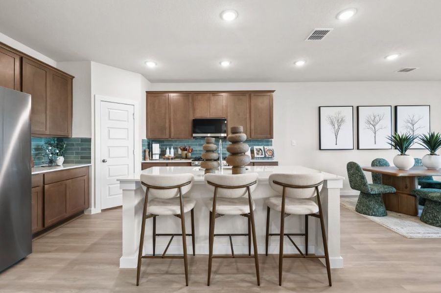 A kitchen with a table and chairs. A kitchen with a table and chairs.