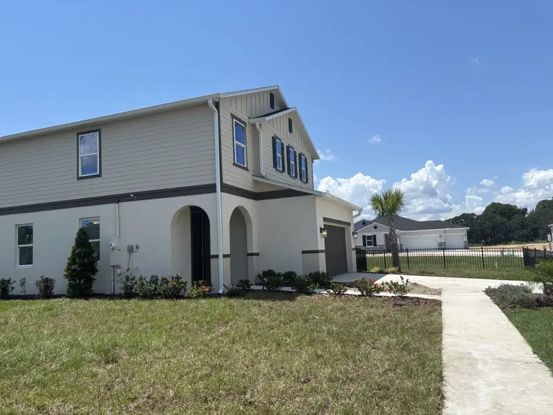 A modern two-story home with lush landscaping in Silver Lake Estates I by KB Home (Leesburg, FL).
