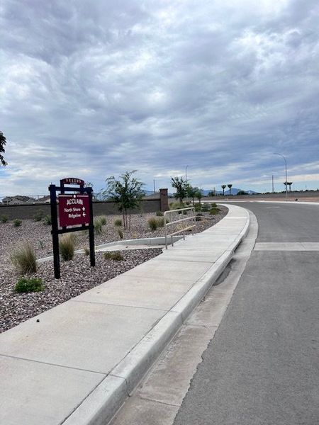 A welcoming entrance in Ridgeline at Acclaim by Fulton Homes, Avondale, AZ, with landscaped pathways and open skies.