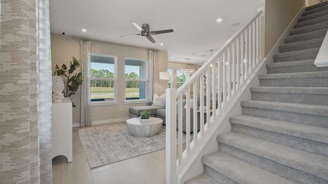 Beautiful entryway at Cyrene at Harmony by DRB Homes, featuring an open staircase Beautiful entryway at Cyrene at Harmony by DRB Homes, featuring an open staircase