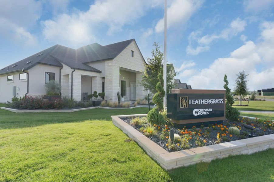 Entrance to the Feathergrass community in Florence, TX, featuring signage and landscaping (Image 9). Entrance to the Feathergrass community in Florence, TX, featuring signage and landscaping (Image 9).