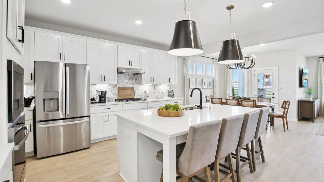 Kitchen with quartz countertops, tile backsplash, and pendant lighting Kitchen with quartz countertops, tile backsplash, and pendant lighting