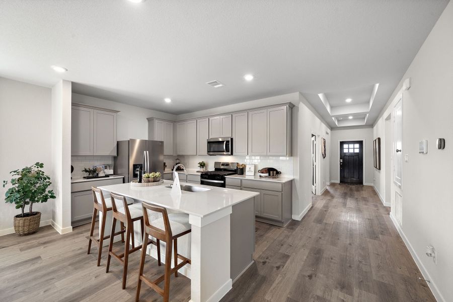 A kitchen with white cabinets.