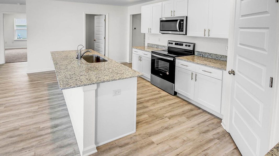 Furnished interior in a model home at Ashton Park Phase III in Freeport (Image 7).