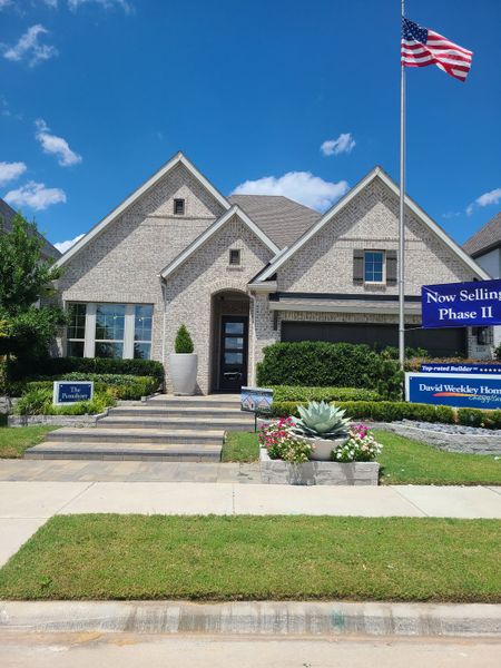 A charming brick home with manicured landscaping in The Parks at Wilson Creek by David Weekley Homes, Celina, TX. A charming brick home with manicured landscaping in The Parks at Wilson Creek by David Weekley Homes, Celina, TX.