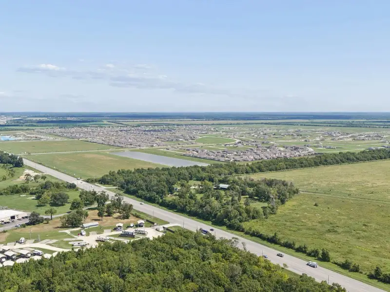 Aerial view of the River Ranch Meadows community in Dayton, TX, showing layout and nearby surroundings (Image 1). Aerial view of the River Ranch Meadows community in Dayton, TX, showing layout and nearby surroundings (Image 1).