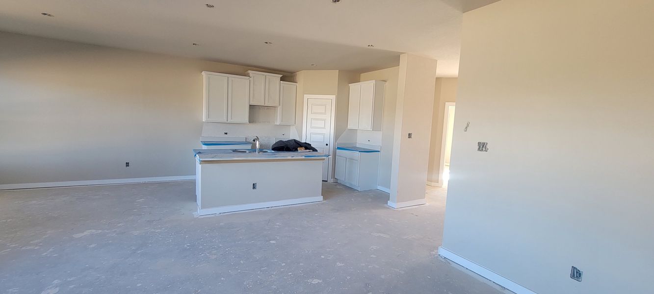 A spacious, unfinished kitchen with white cabinets and ample natural light. Perfect canvas for your design ideas.