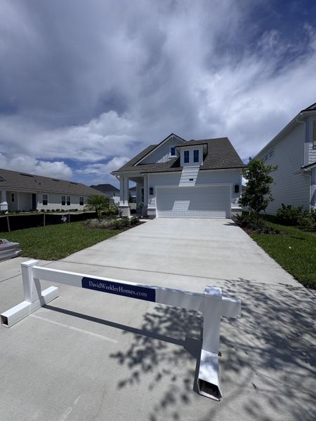 A beautiful two-story white home with a large driveway in Seabrook Village 40' Front Entry by David Weekley Homes (Nocatee, FL). A beautiful two-story white home with a large driveway in Seabrook Village 40' Front Entry by David Weekley Homes (Nocatee, FL).