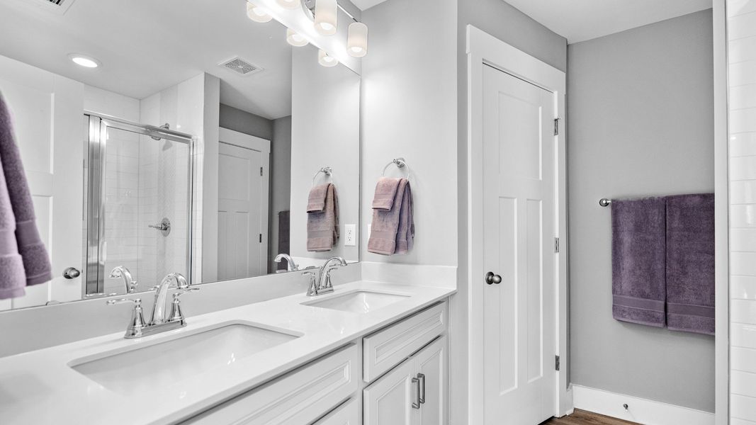 Double sink vanity in primary bathroom in two story townhome at Ransdell Pointe by DRB Homes in Spartanburg, SC