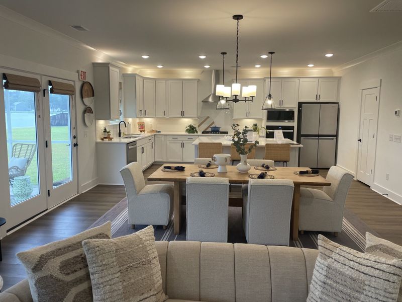 A modern kitchen and dining area with sleek cabinetry, cozy seating, and stylish lighting.