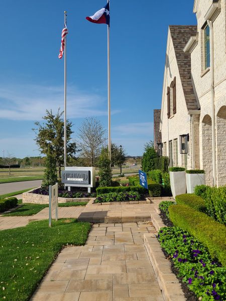 A beautiful brick home with manicured landscaping in Star Trail: 65ft. lots by Highland Homes (Prosper, TX).