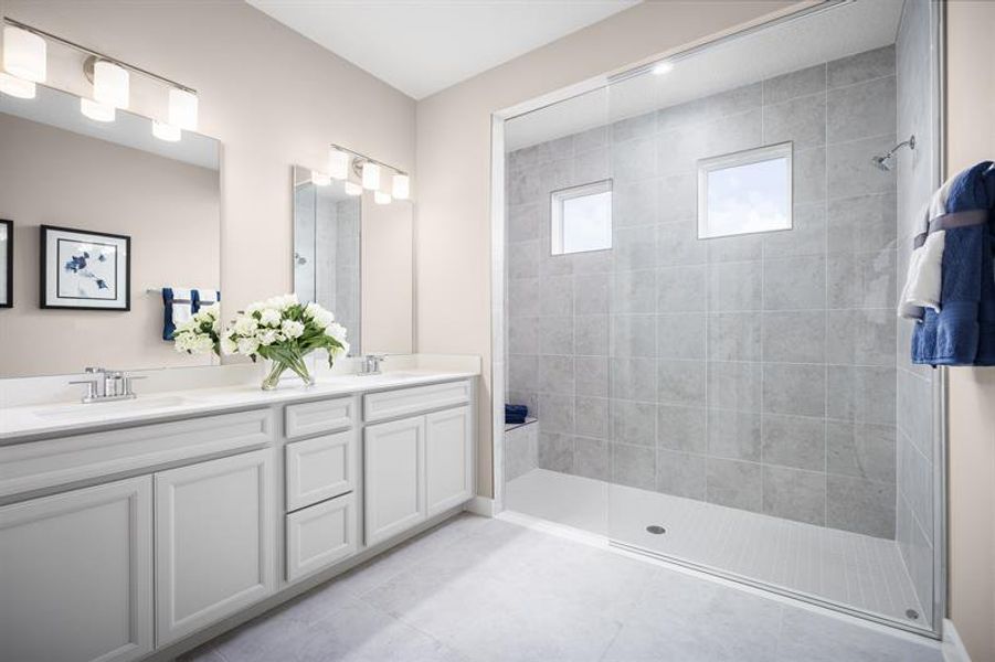 Well‑designed bathrooms featuring double vanity and an expansive walk‑in shower.