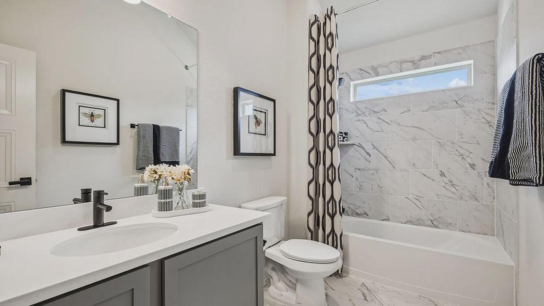 Luxurious marble tile bathroom featuring sleek fixtures in the exclusive Churchill community. Luxurious marble tile bathroom featuring sleek fixtures in the exclusive Churchill community.