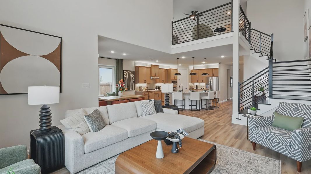 Elegant open-plan living area with airy loft, sleek iron staircase, and premium wood finishes in Westridge.