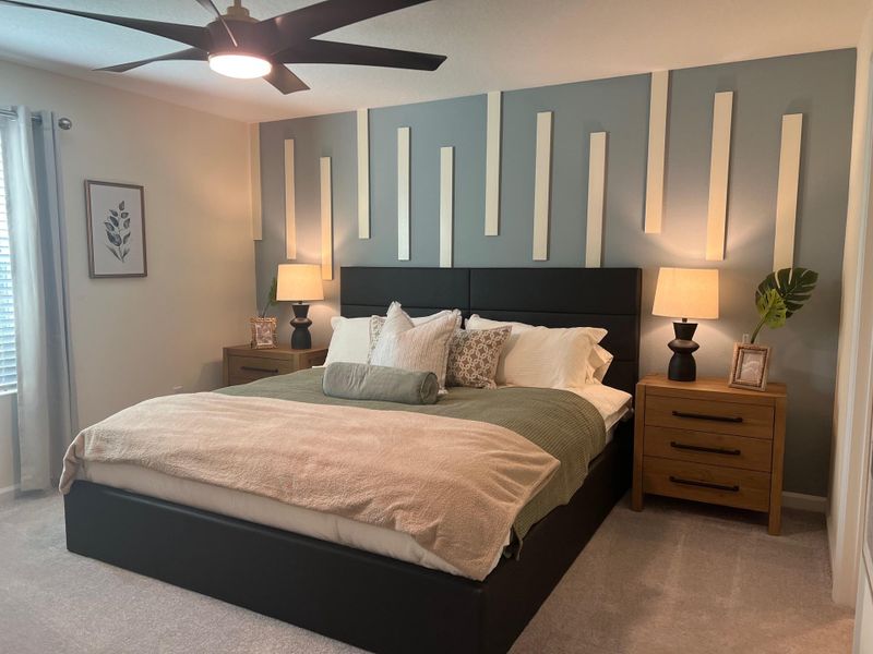 A contemporary bedroom with a unique accent wall, cozy bedding, and stylish nightstands with modern lamps.