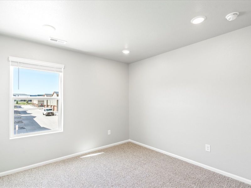 Bedroom in the Woodland floorplan at a Meritage Homes community in Broomfield, CO.