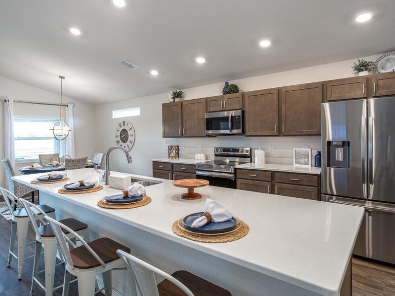 Meals are a delight in your bright, open kitchen with a large counter-height island - Serendipity model home in Auburndale, FL