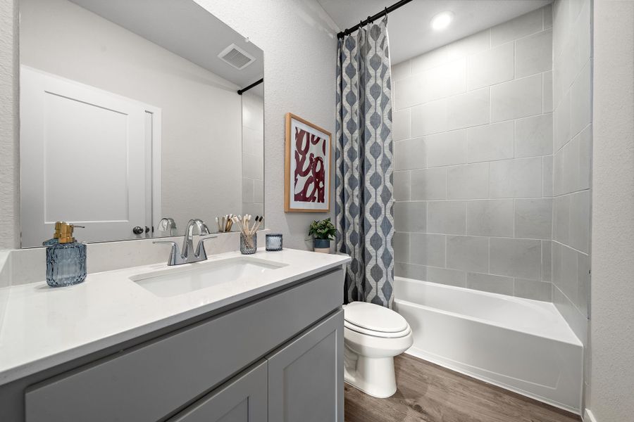 A bathroom with a tub sink and toilet.