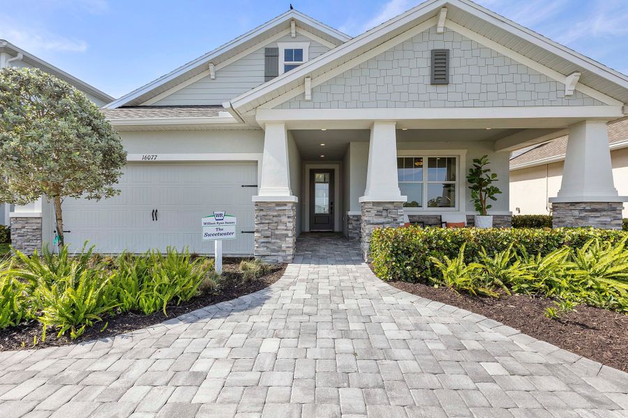 Front exterior of a home in the The Sanctuary – Resort Collection community, located in Punta Gorda, FL (Image 23).