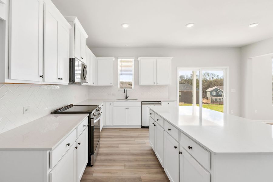 A kitchen with white cabinets. A kitchen with white cabinets.