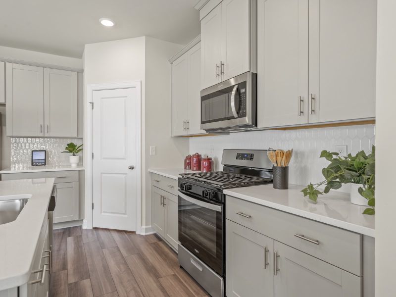 The large kitchen features stunning finishes and corner pantry.