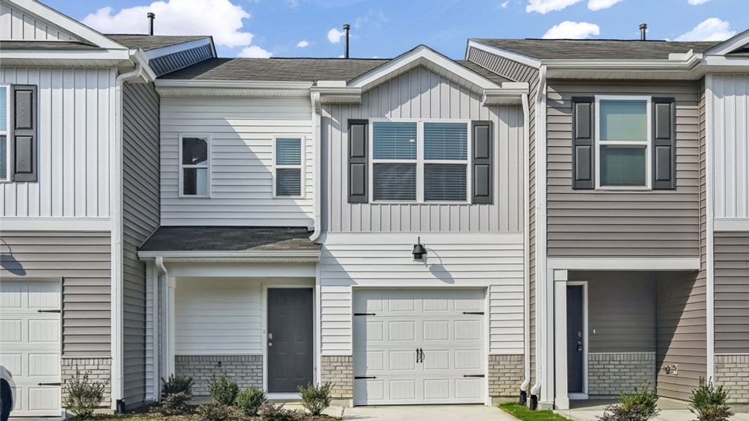 Front exterior of a home in the The Townes at Honeycutt Oaks community, located in Angier, NC (Image 2).