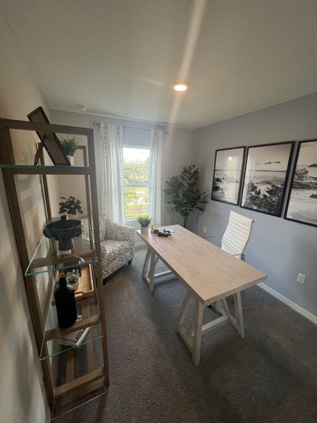 A stylish home office with a sleek wooden desk, modern chair, and artful shelving, creating a productive, serene space.