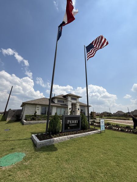 A charming brick home with manicured landscaping in Stonecreek Estates 60' by Perry Homes (Richmond, TX).