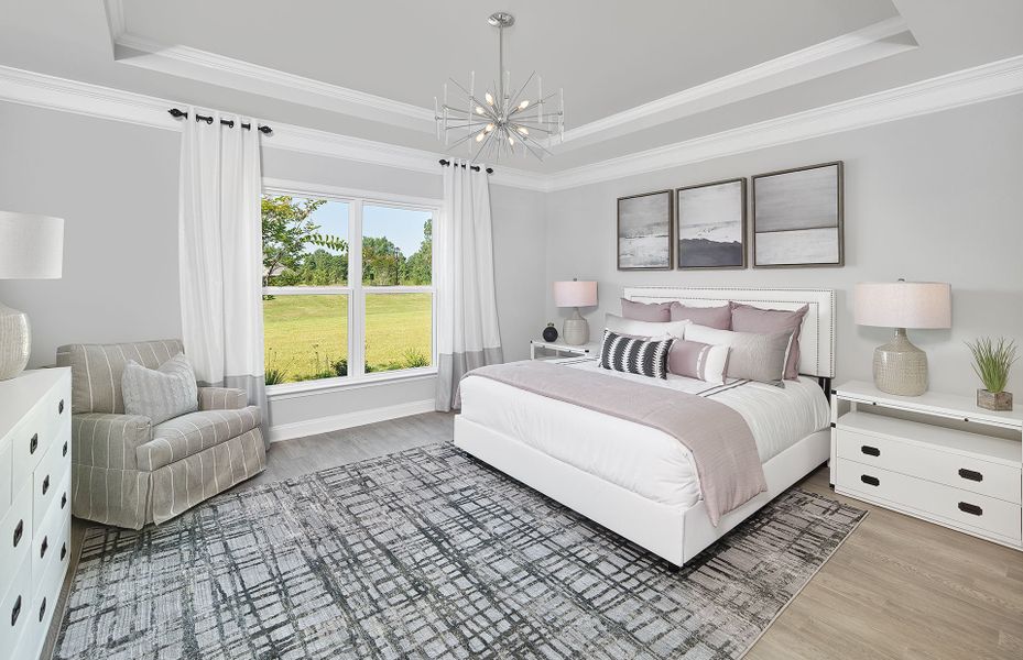 Owner Suites with a tray ceilings and large windows.