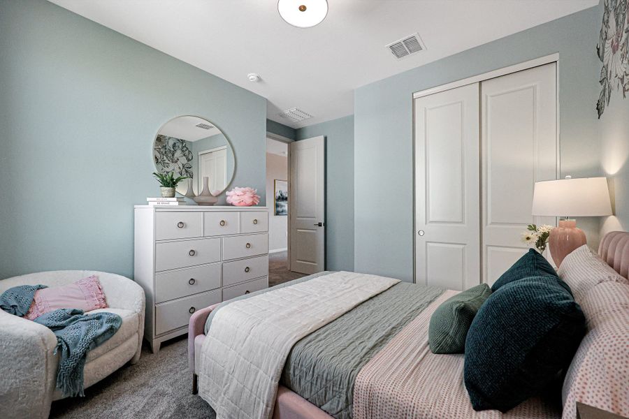 A bedroom with a bed and a mirror. A bedroom with a bed and a mirror.