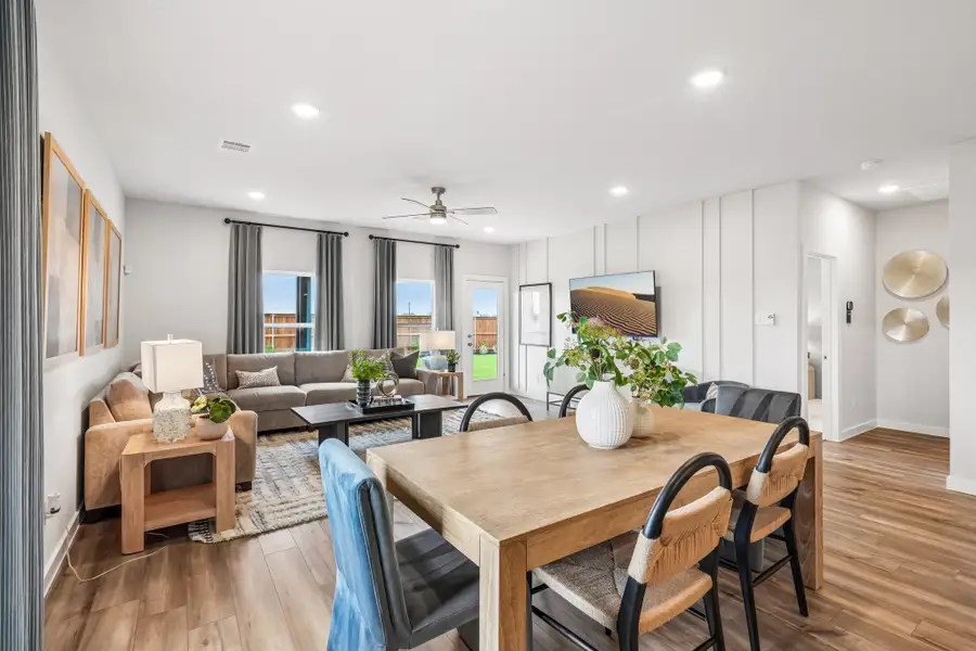 A large living room with a dining table and chairs.