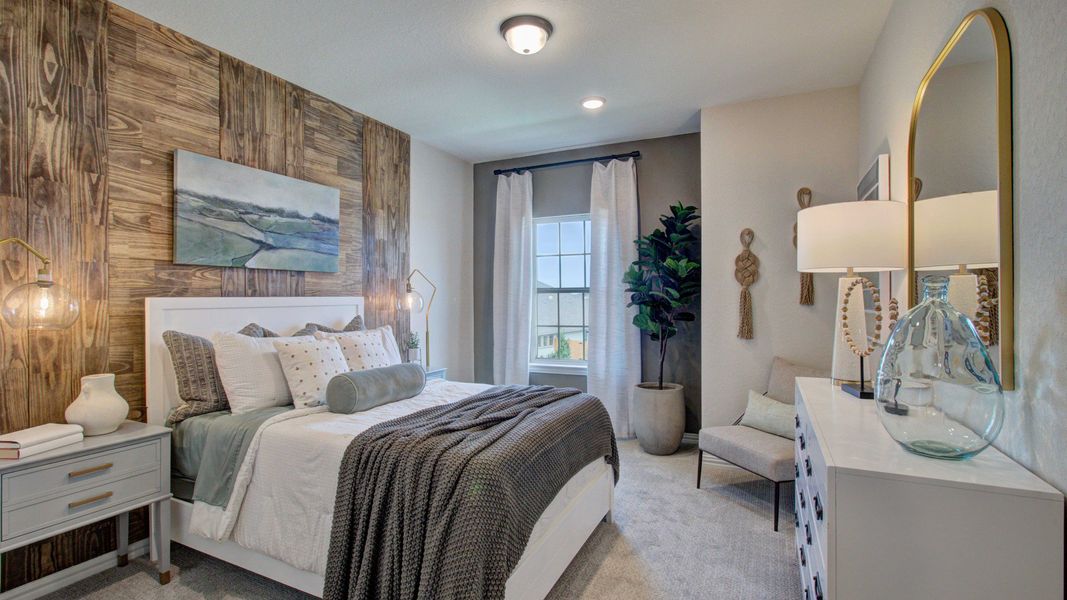 Revel in the refined wood accent wall and chic lighting in this Meyer Ranch luxury bedroom.