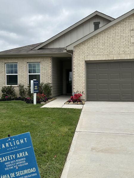 Charming brick home with manicured lawn in Royal Pines by Starlight Homes, Porter, TX.