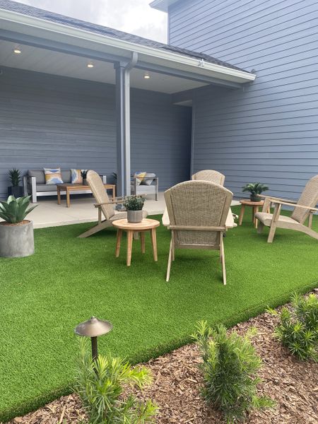 A cozy patio with wicker seating, vibrant greenery, and a covered lounge space. Perfect for outdoor relaxation. A cozy patio with wicker seating, vibrant greenery, and a covered lounge space. Perfect for outdoor relaxation.