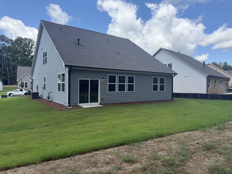 A modern gray home with a spacious backyard in Candleberry Place by Lennar (Sharpsburg, GA).