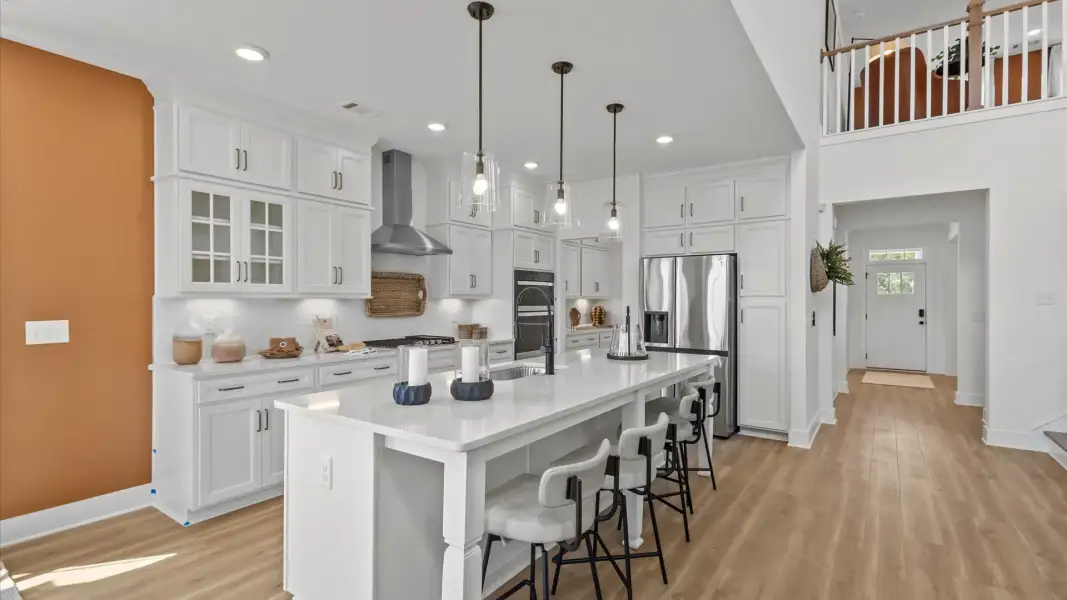 Superior craftsmanship shines in this modern kitchen with a center island and open flow by DRB Homes