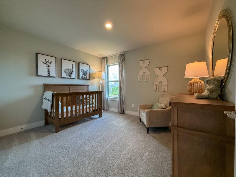 A cozy nursery with a wooden crib, soft lighting, and animal-themed decor creates a welcoming and serene atmosphere.