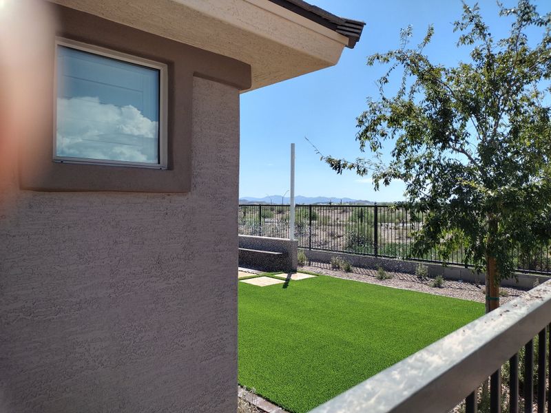 Charming home with a lush yard and scenic views in The Villas at Mystic by Brightland Homes (Peoria, AZ).