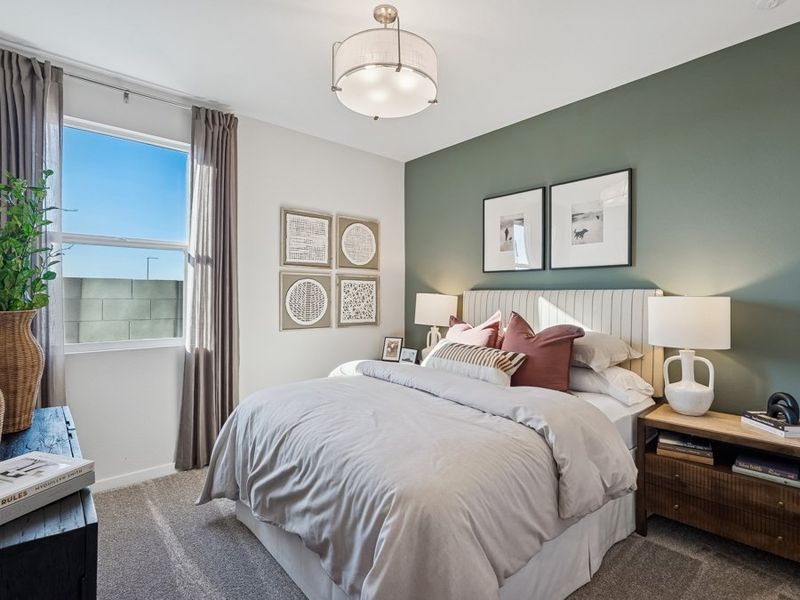 A bedroom with a bed and a window. A bedroom with a bed and a window.