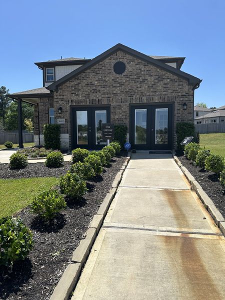 A charming brick home with manicured hedges in Chapel Run by Lennar (Montgomery, TX).