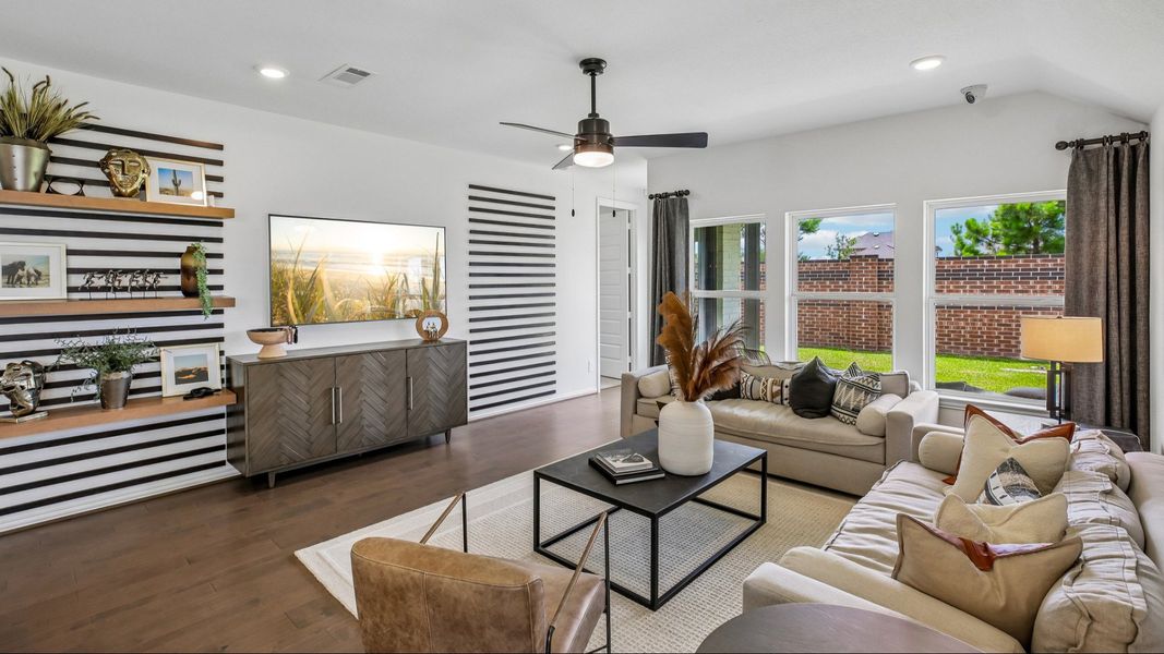Luxurious living room in Cypress Green featuring a chic striped wall, stylish furnishings, and expansive windows. Luxurious living room in Cypress Green featuring a chic striped wall, stylish furnishings, and expansive windows.