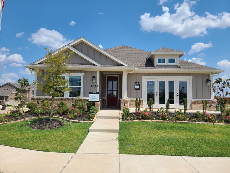 A charming single-story home with a manicured lawn and vibrant garden in Coyote Meadows 40s by Ashton Woods (Anna, TX). A charming single-story home with a manicured lawn and vibrant garden in Coyote Meadows 40s by Ashton Woods (Anna, TX).