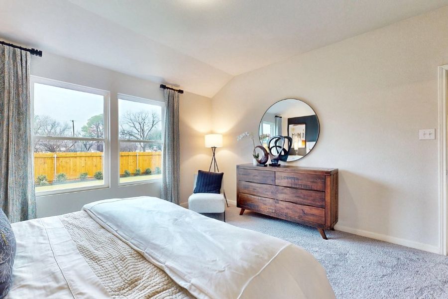 A bedroom with a large window. A bedroom with a large window.
