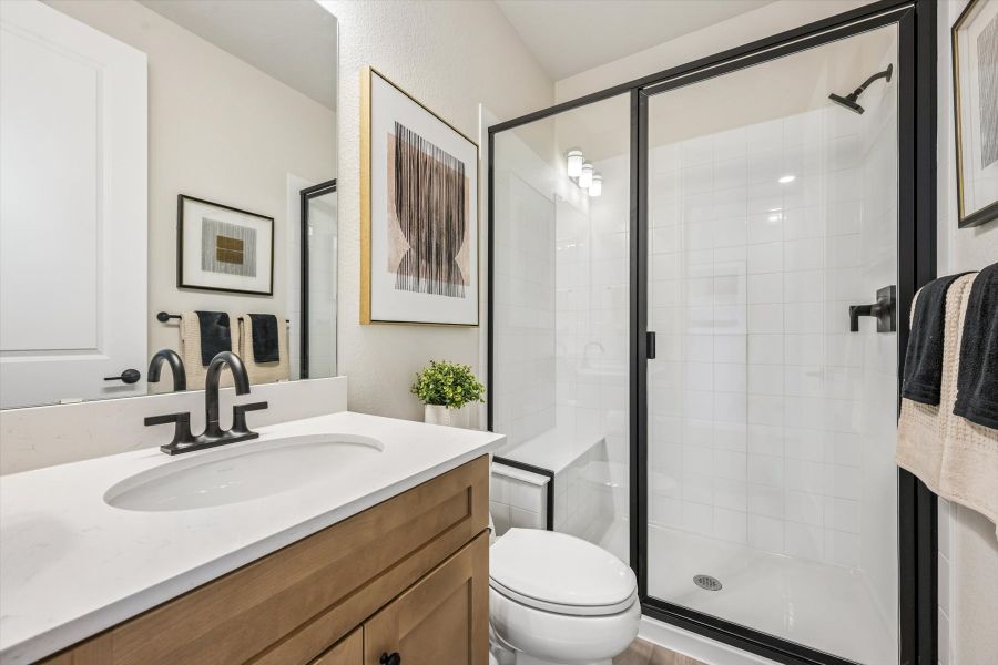 A bathroom with a glass shower. A bathroom with a glass shower.