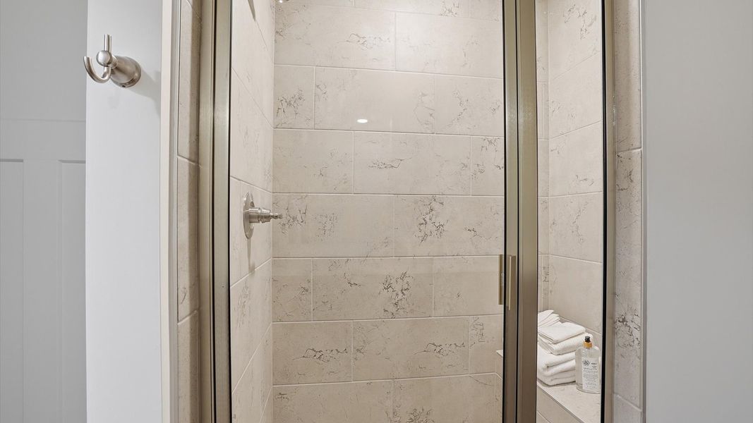 Memorable mornings begin in this elegant primary bathroom with a tiled walk-in shower and modern features in Greenville, SC