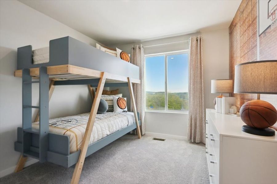 A bedroom with a bed and a window.