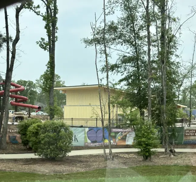 A recreational area with slides and sports courts in The Highlands by Caldwell Homes (Porter, TX).