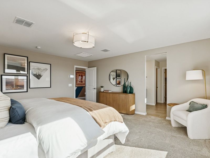 A bedroom with a bed and a mirror.