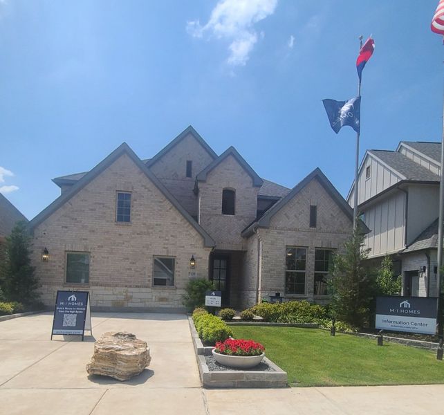 A charming brick home with a landscaped yard at Aster Park by M/I Homes in McKinney, TX.